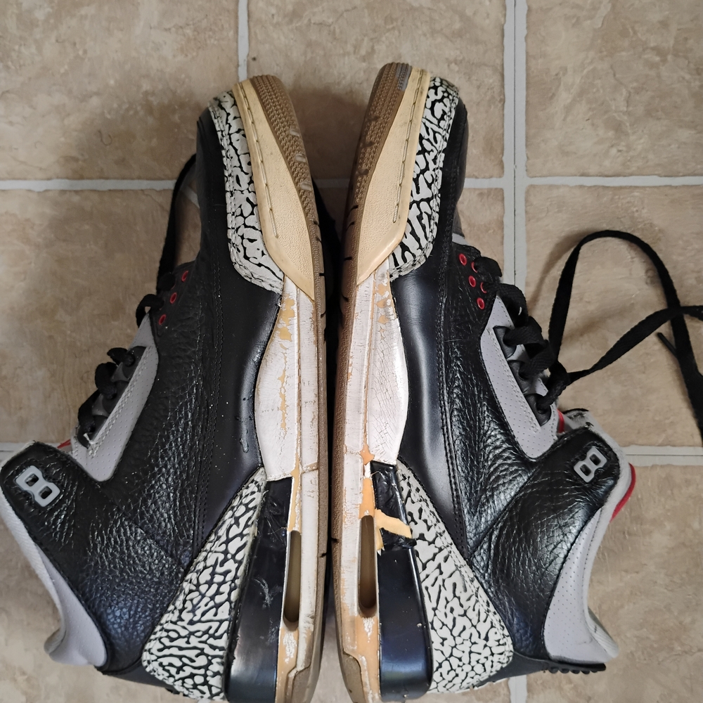Black and Gray Sneakers with Red Accents